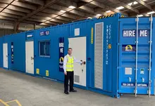 A container hub with multiple shipping containers arranged for storage and logistics in an industrial area.