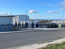 New self-storage facility with multiple storage units and secure gated access, representing expanded community storage solutions.
