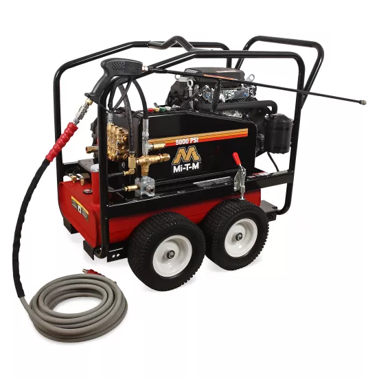 Lavadora a presión de 5,000 psi Mi-T-M negra y roja que se utiliza para lavar una pieza de maquinaria pesada